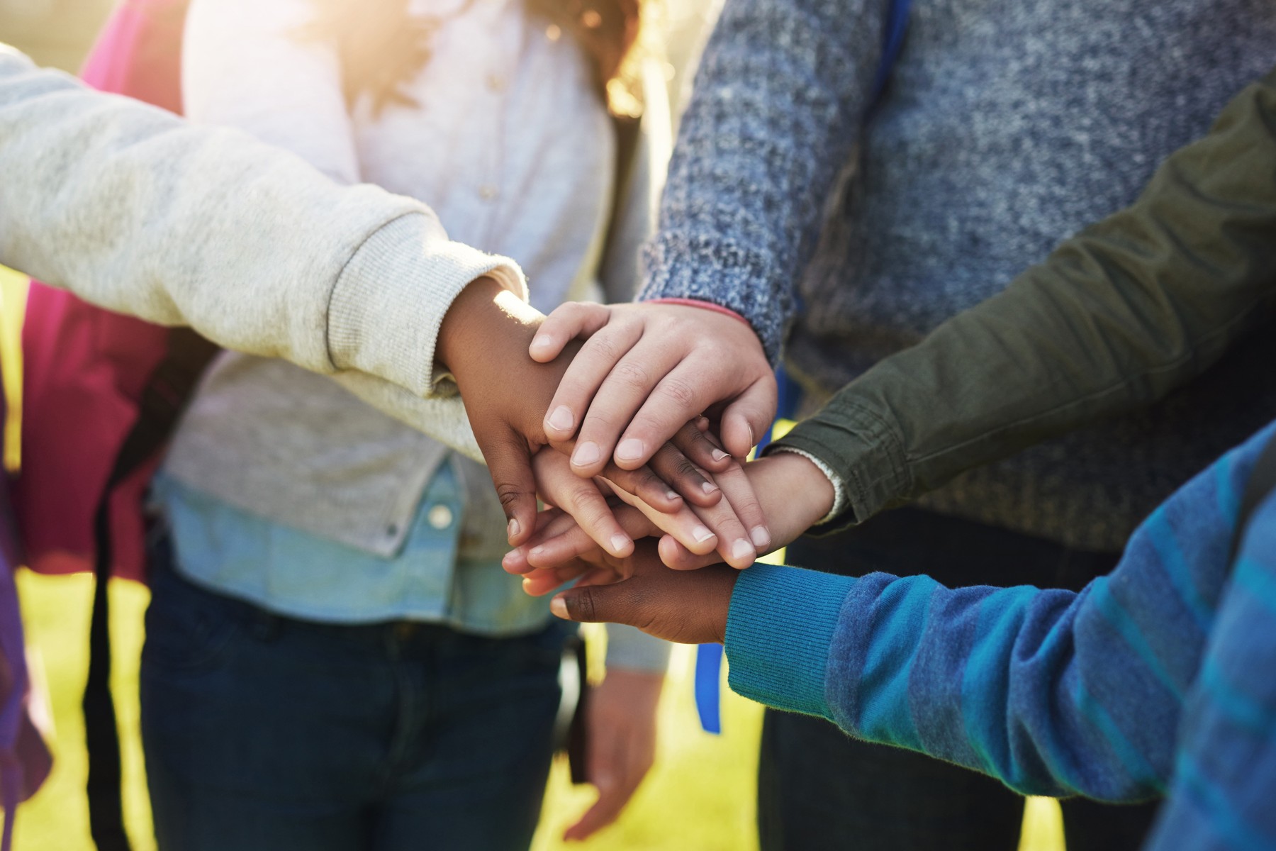 Children putting their hands together